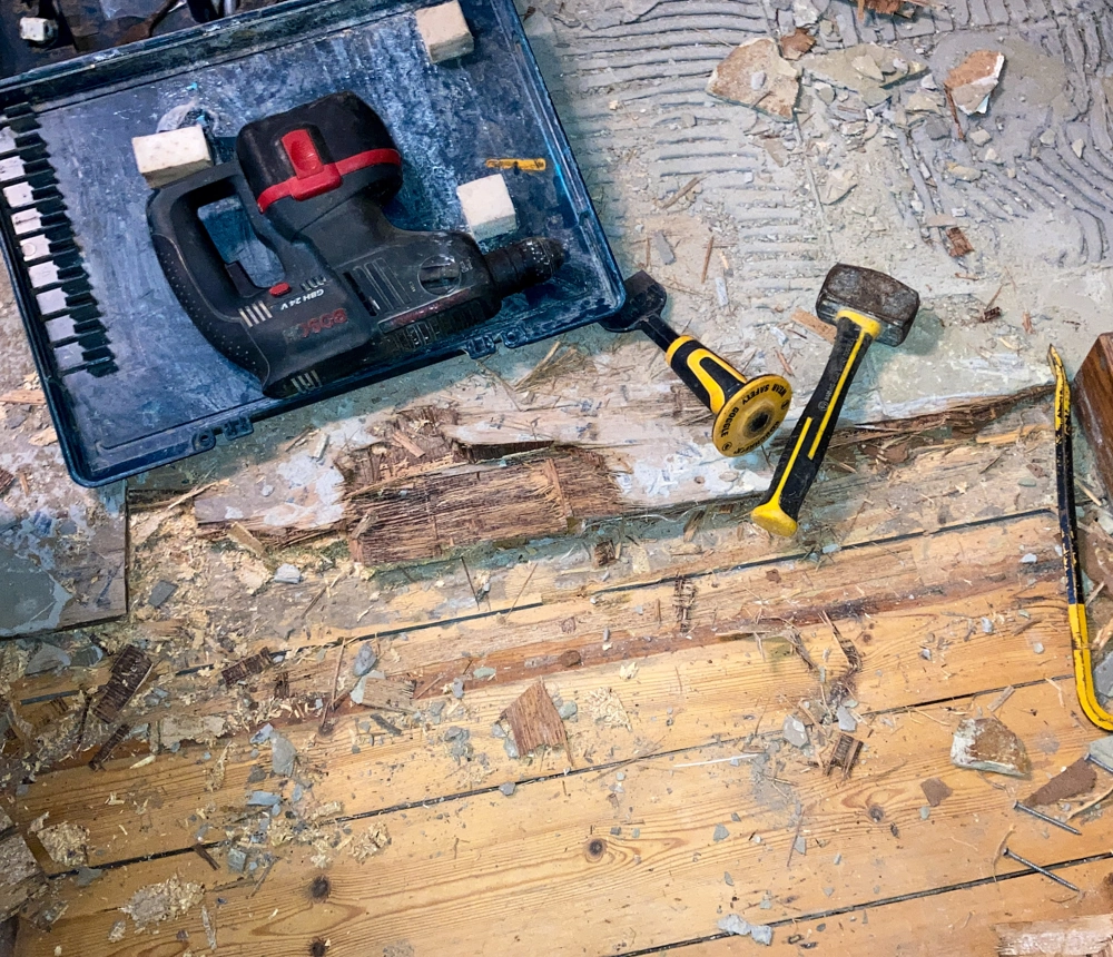 Abbrucharbeiten auf Holzdielen mit Bohrhammer, Schlegelhammer, Meißeln und Schutt